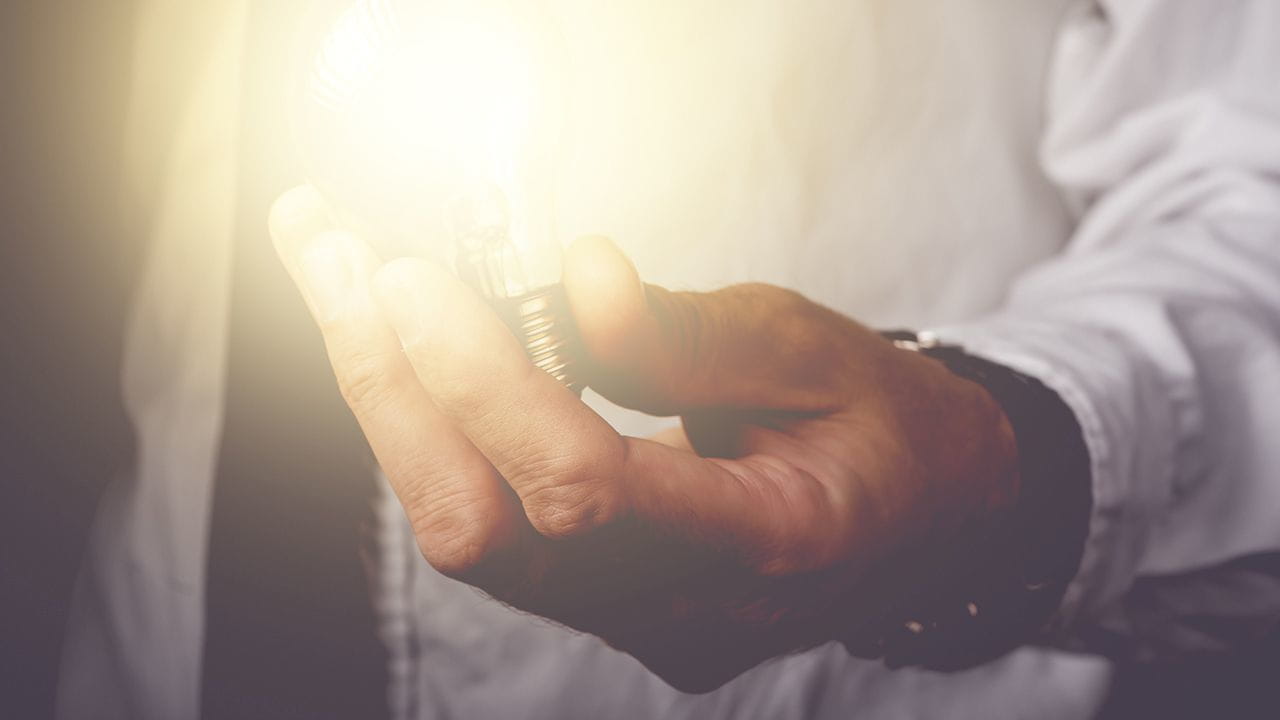 Man holding a light bulb in his hand